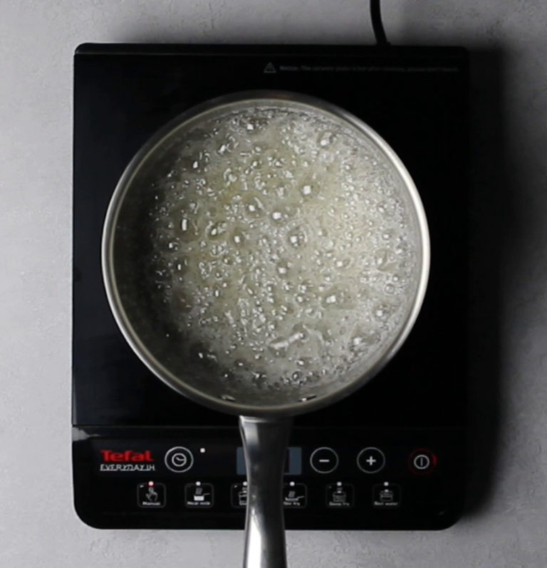 Sugar and water mixture boiling in pot