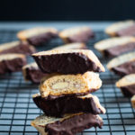 Chocolate almond biscotti stacked on cooling rack