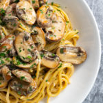 Close up of creamy mushroom pasta in a bowl, viewed from above