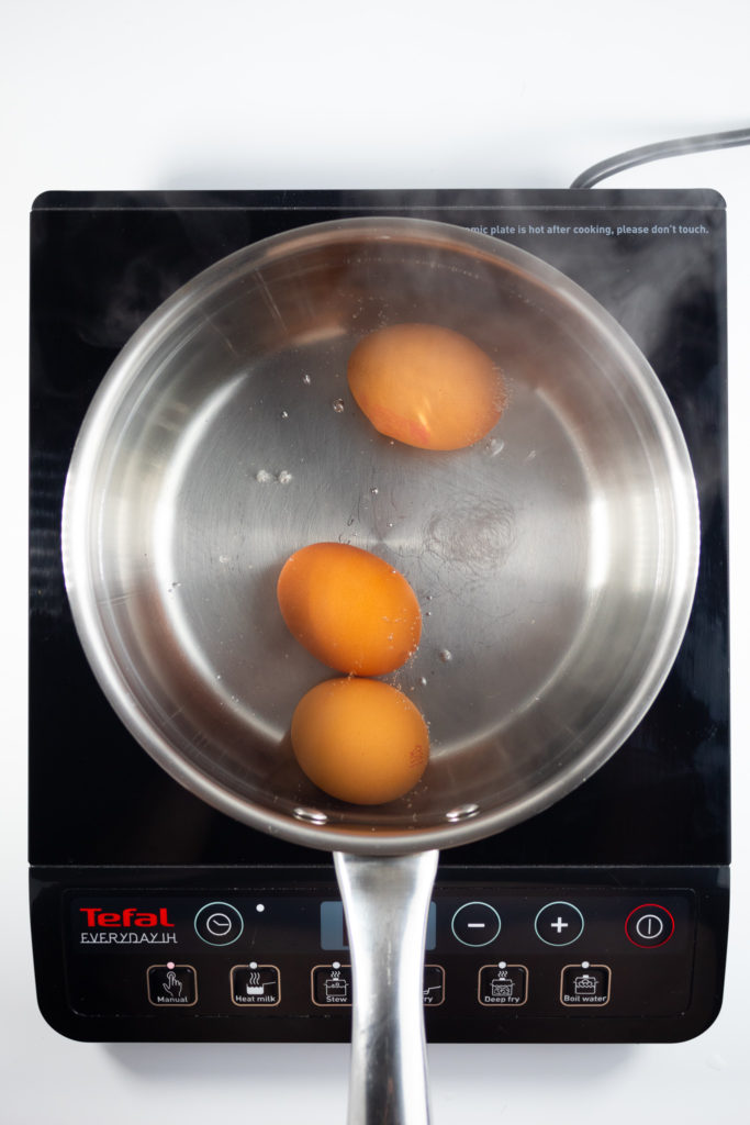 3 eggs in a pan of simmering water from above