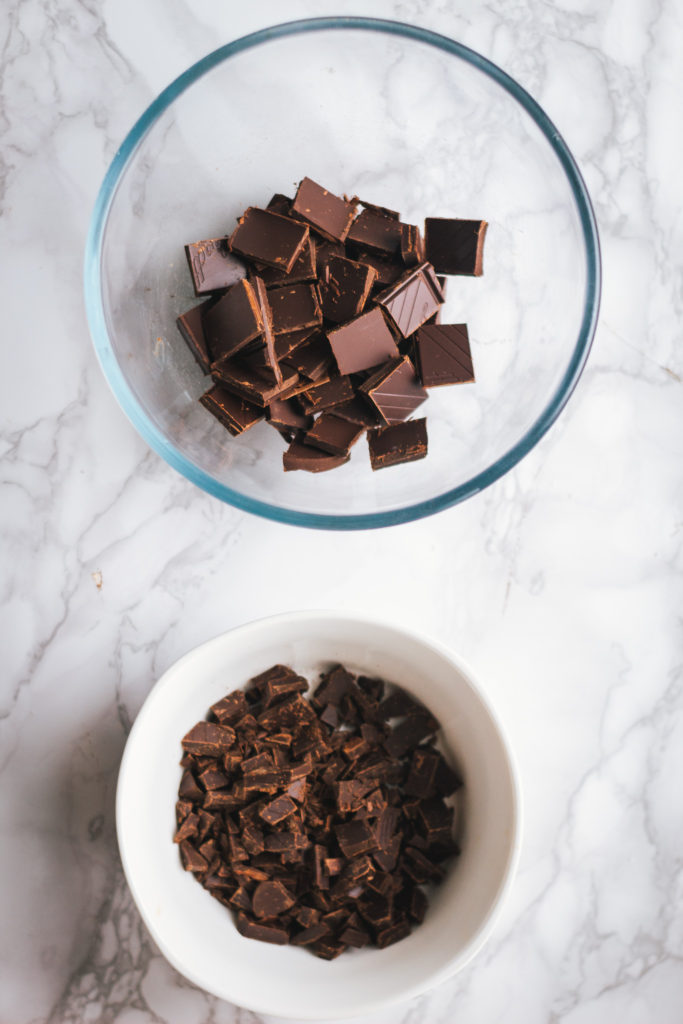 Two bowls of chopped chocolate and chocolate chunks