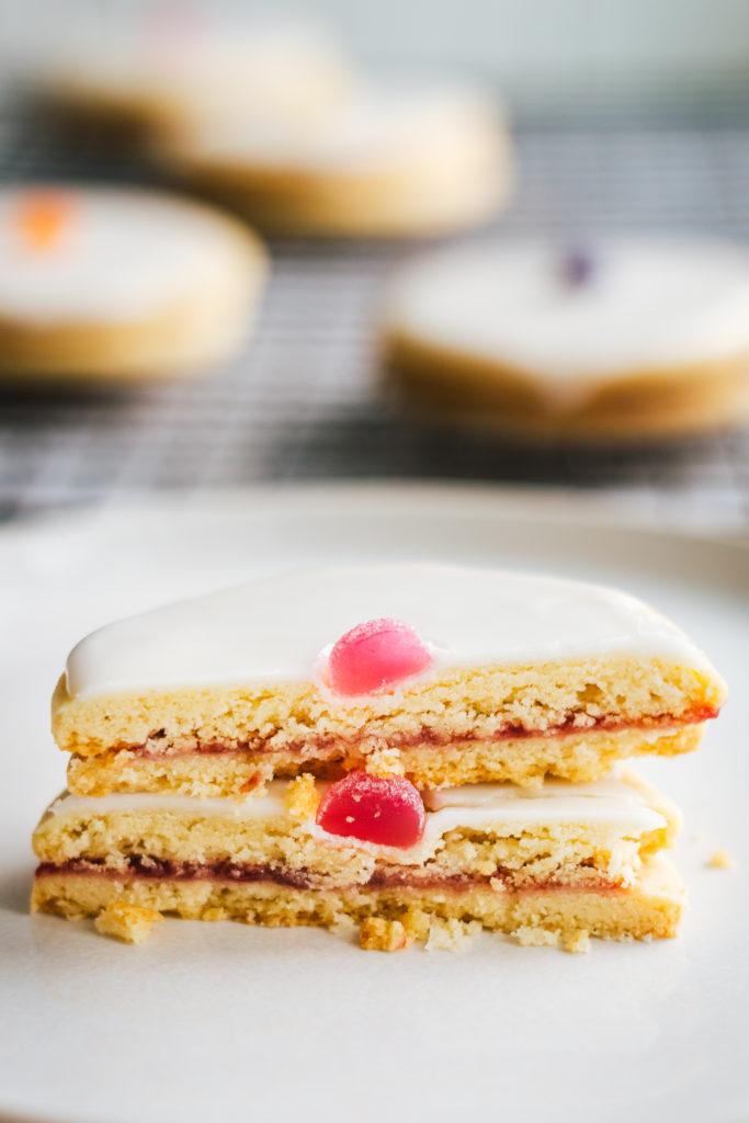 Empire biscuit cut in half to show crumb with whole empire biscuits in the rear view