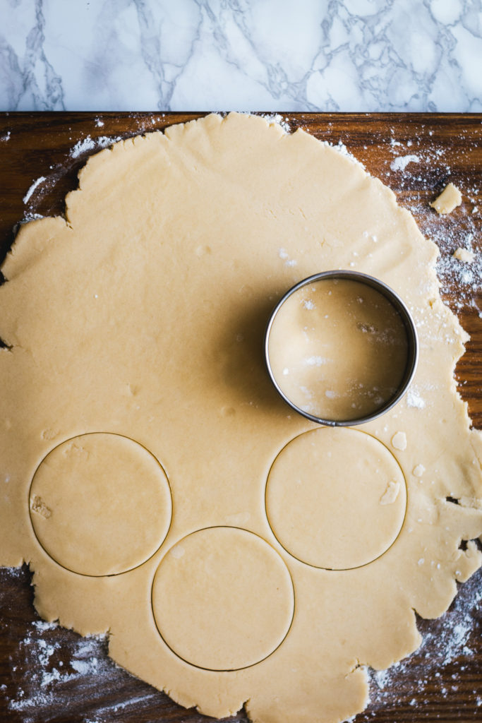 Empire biscuit dough cut into rounds with cookie cutter
