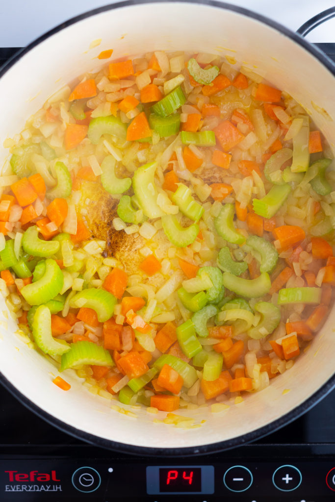 Chopped vegetables sauteing in a pot