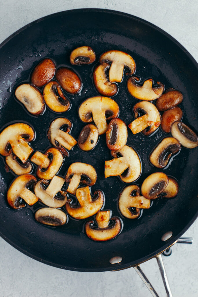 Sauteed golden mushrooms in a frying pan