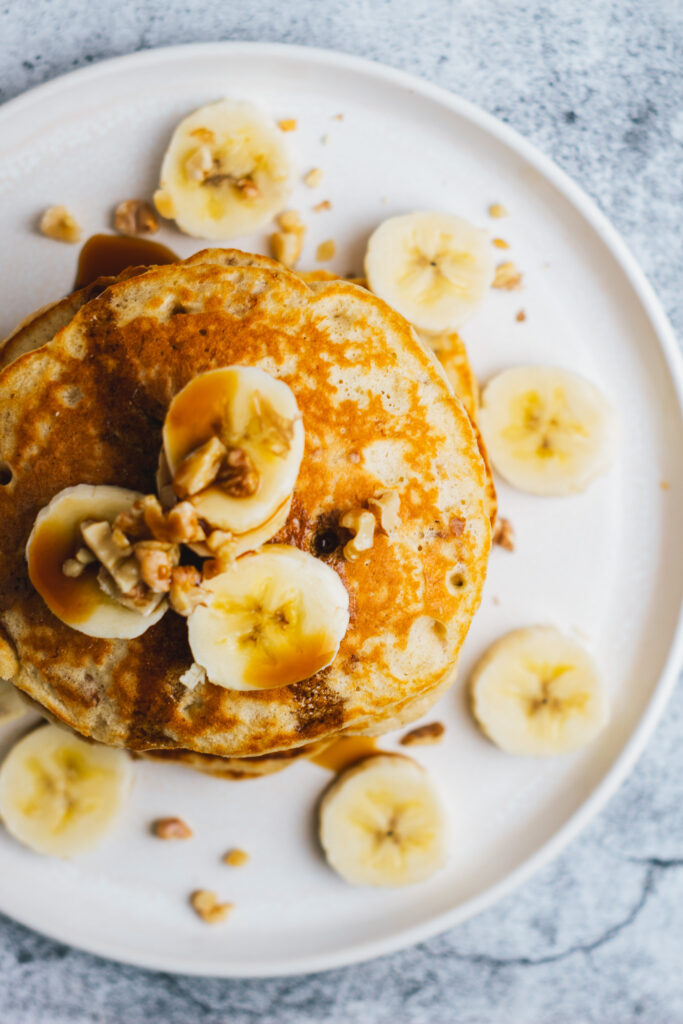 Banana Walnut pancakes on a plate viewed from above