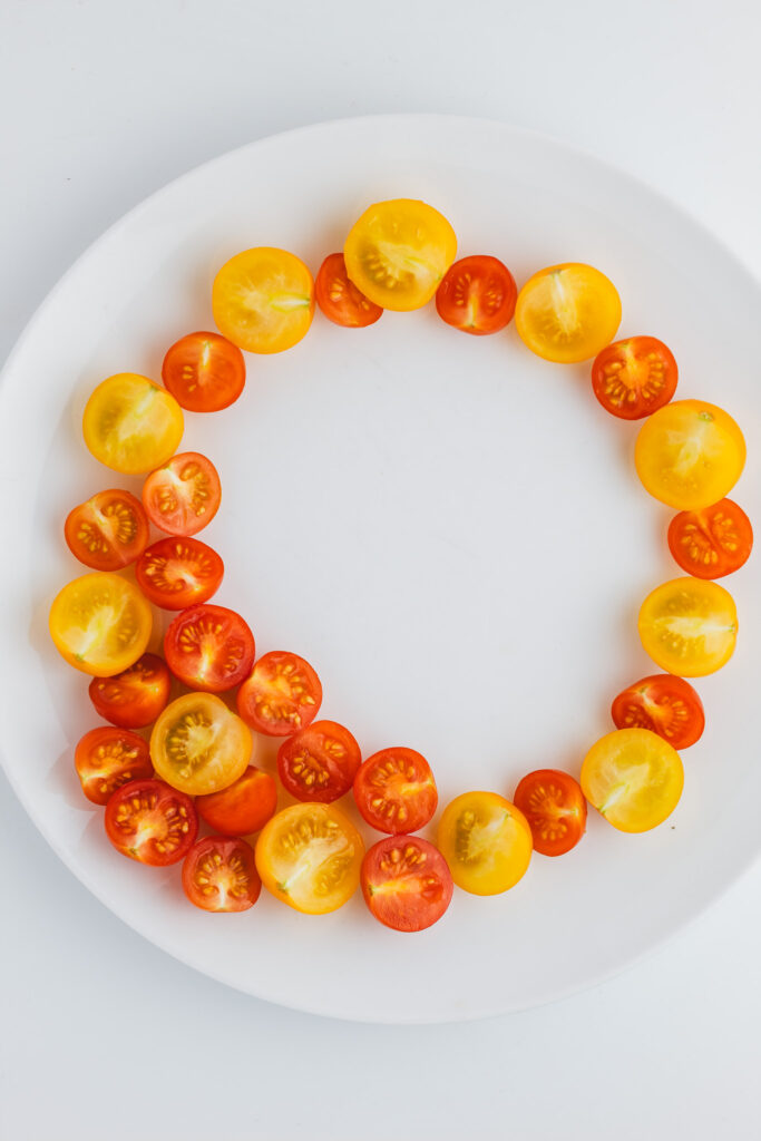 Sliced cherry tomatoes arranged on a plate