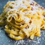 Tagliatelle Carbonara on a plate with grated parmesan