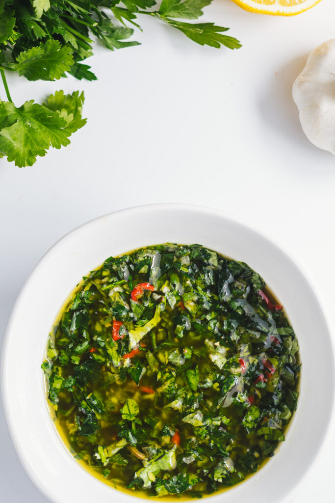 Bowl of Chimichurri Verde from above with herbs and garlic