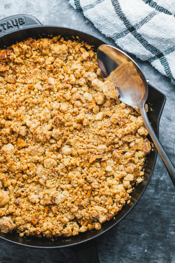 Cast Iron apple crisp with a serving spoon