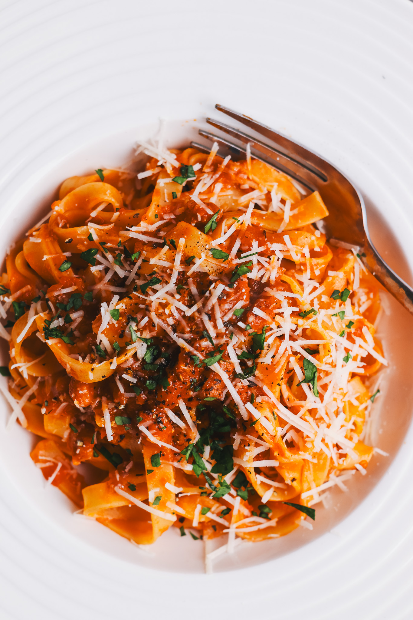 Tagliatelle amatriciana in a bowl with a fork