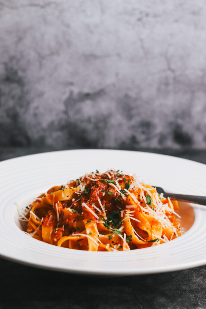 Tagliatelle amatriciana in a bowl with a fork