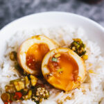 Halved Korean Boiled Eggs in a bowl with rice
