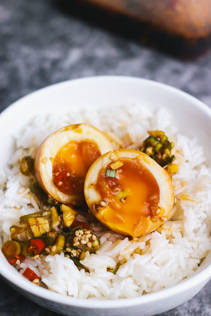 Halved Korean Boiled Eggs in a bowl with rice
