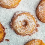 Apple fritters dusted with icing sugar