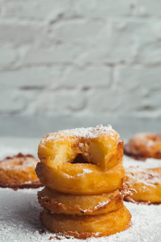 stack of apple rings with a bite from the top fritter
