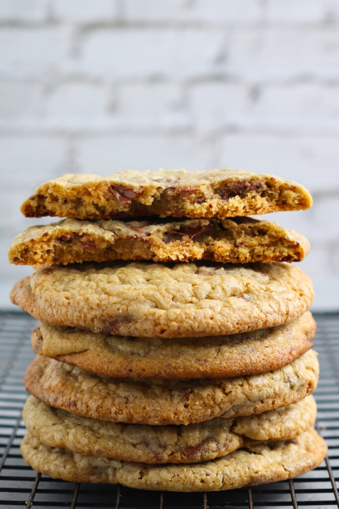 Stack of oat flour cookies with top cookie halved, showing inner crumb