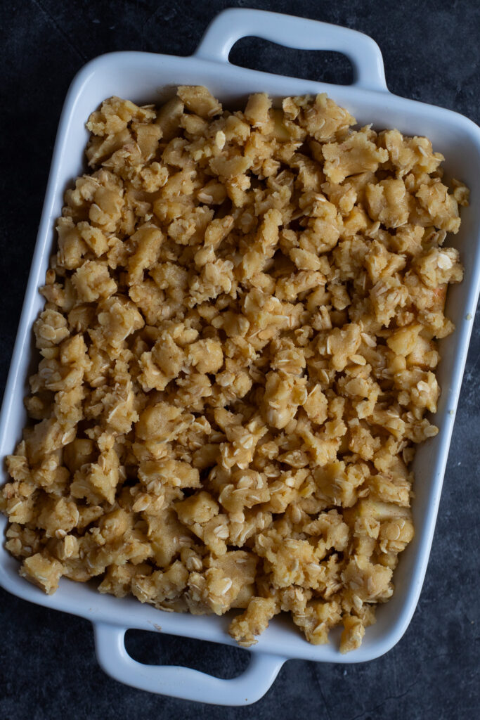 chopped apples and crumble topping in a serving dish ready to be cooked