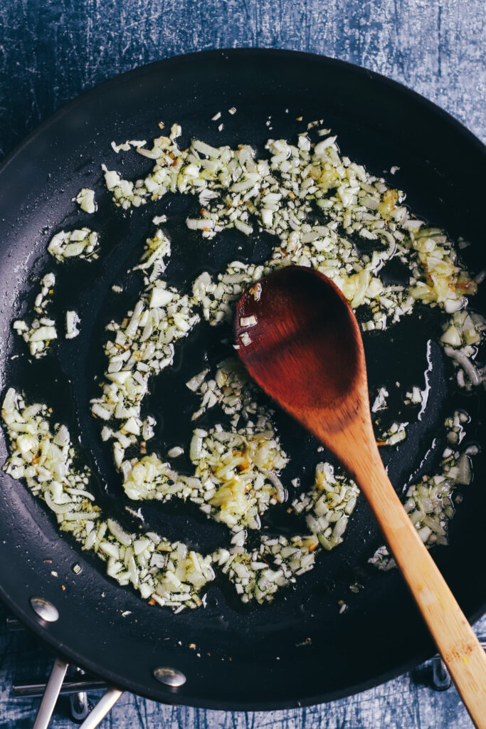 minced garlic and onion in a frying pan