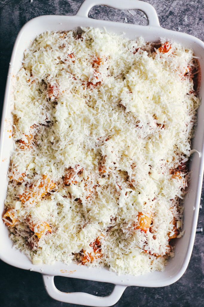 Rigatoni al forno in a baking dish topped with cheese