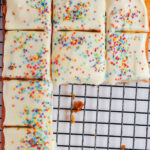 Squares of vanilla traybake on a cooling rack