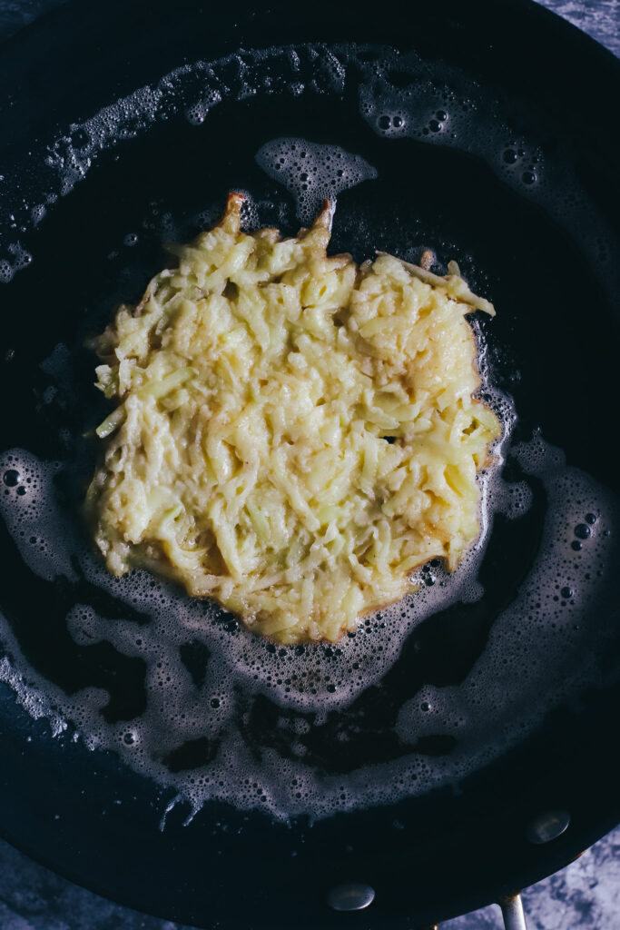 Potato fritter in a frying pan