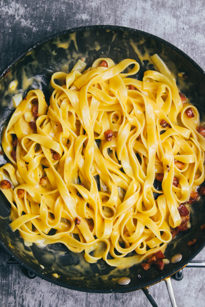 Tagliatelle carbonara in a frying pan