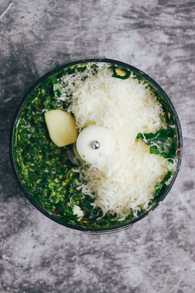 Pesto with parmesan and a garlic clove in a mini blender