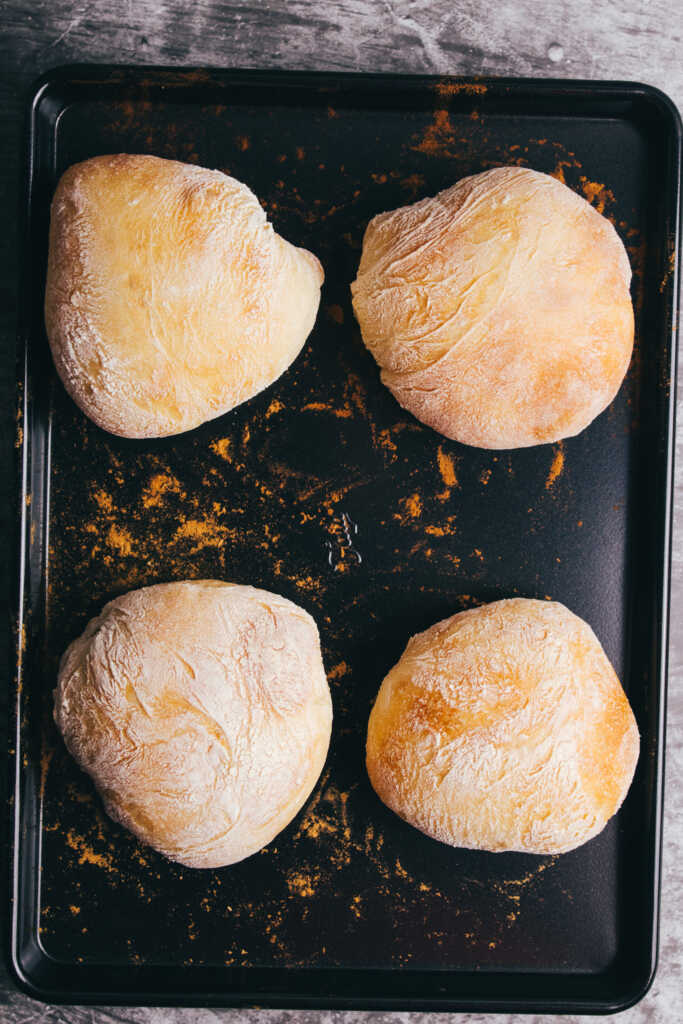 Cooked Ciabatta rolls on a baking tray