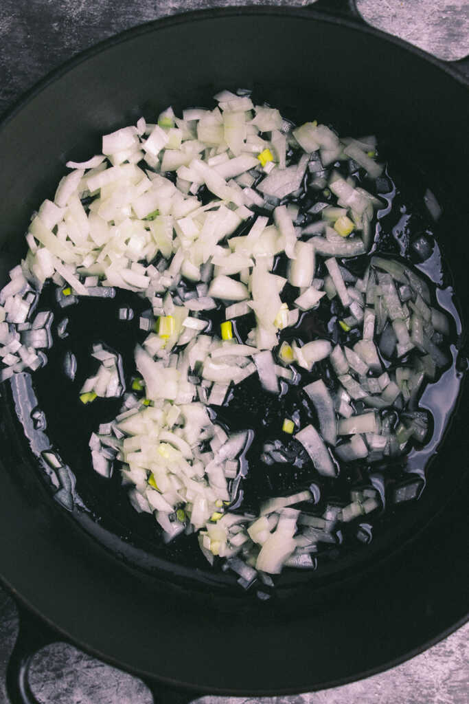 Softened onions in a pot with olive oil
