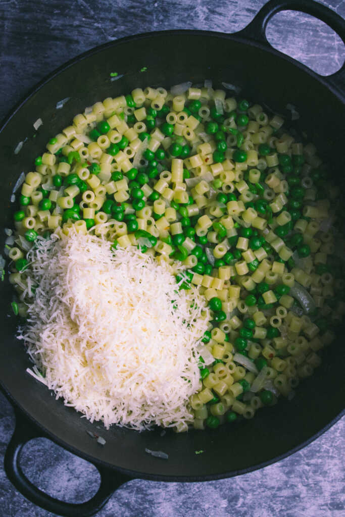 Simmered peas and pasta with parmesan cheese