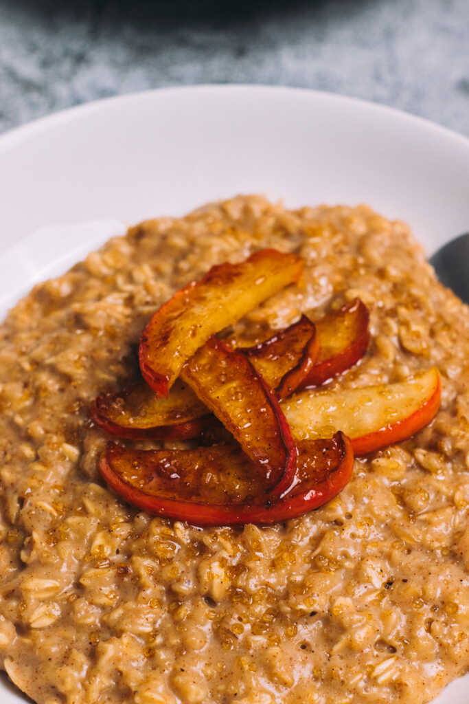 Apple pie porridge in a bowl with a spoon