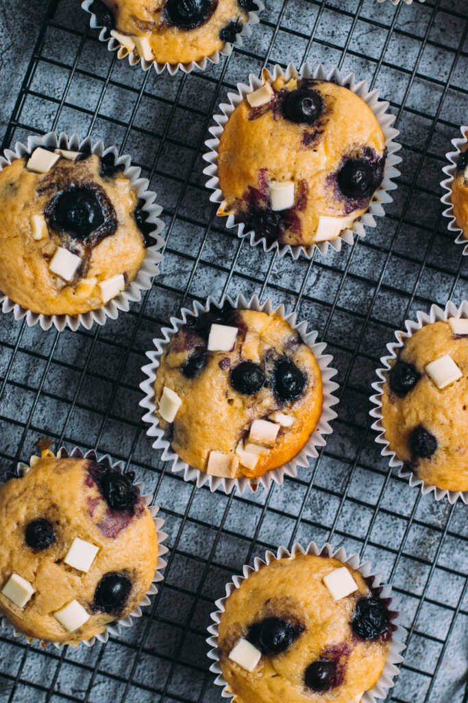 White Chocolate and Blueberry Muffins on a cooling rack
