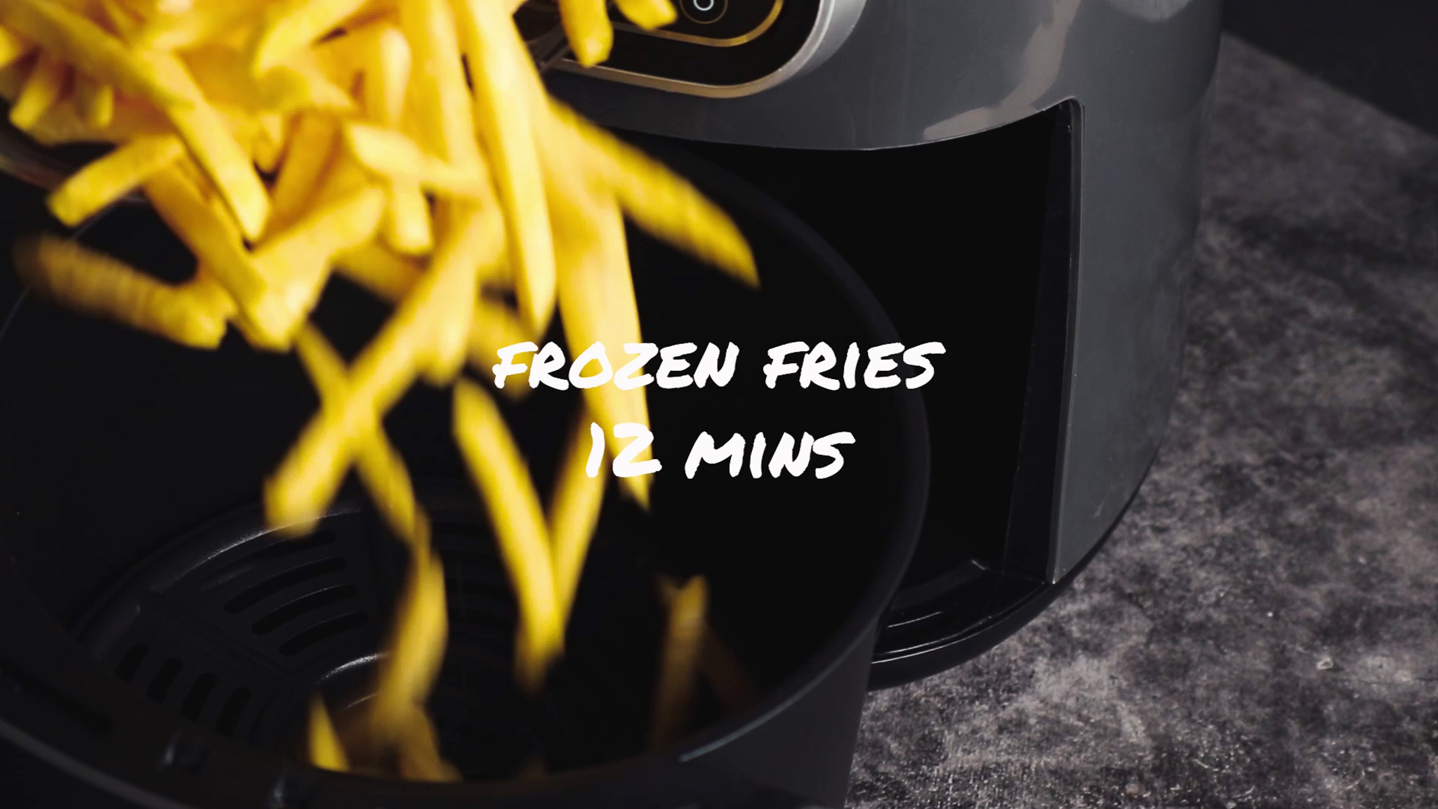 Pouring frozen fries into air fryer basket before cooking