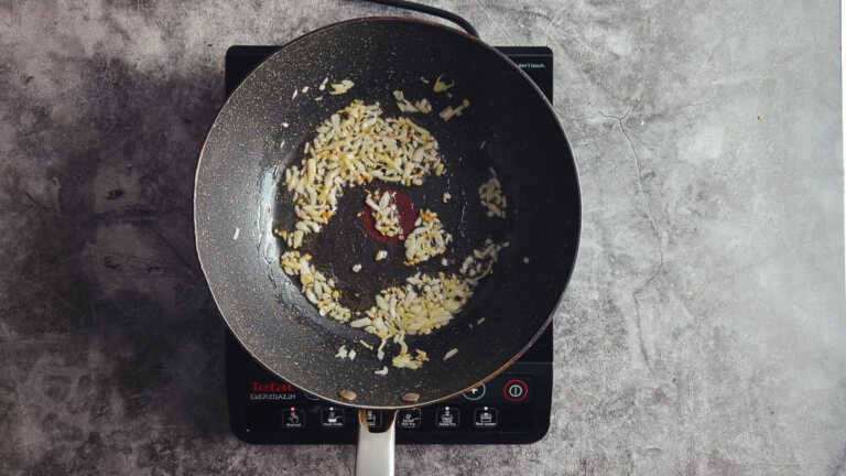 chopped onion in frying pan