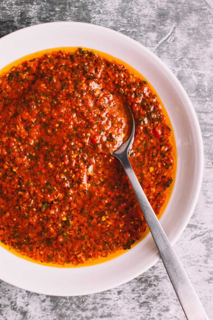 Chimichurri roja in a bowl with a spoon