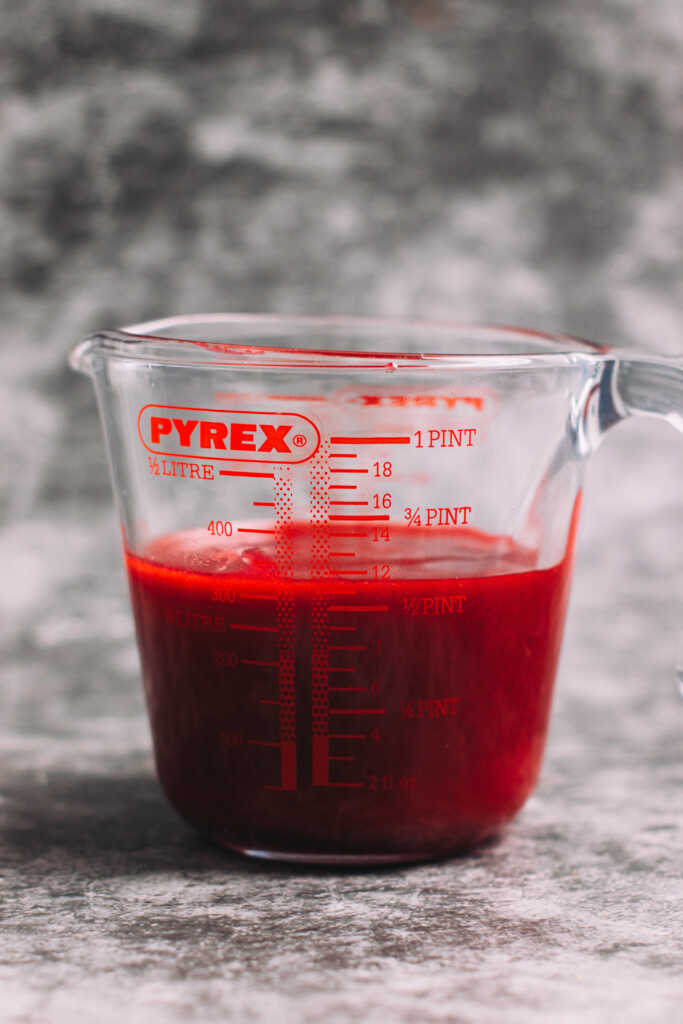 Pureed raspberries in a measuring jug