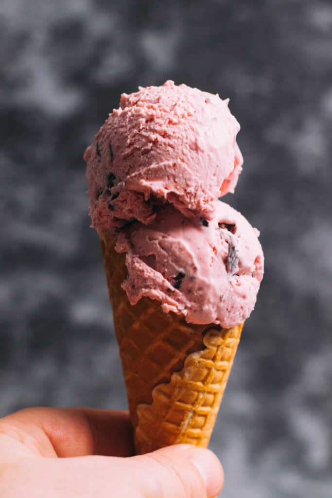 Two scoops of chocolate raspberry ice cream in a cone