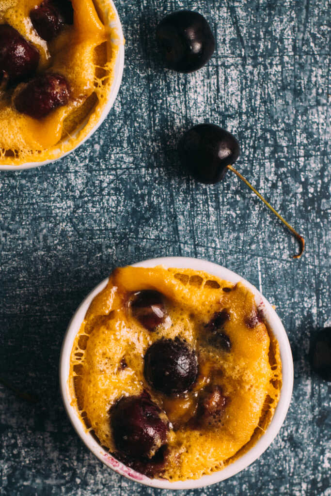 Easy Mini Clafoutis in ramekins surrounded by cherries