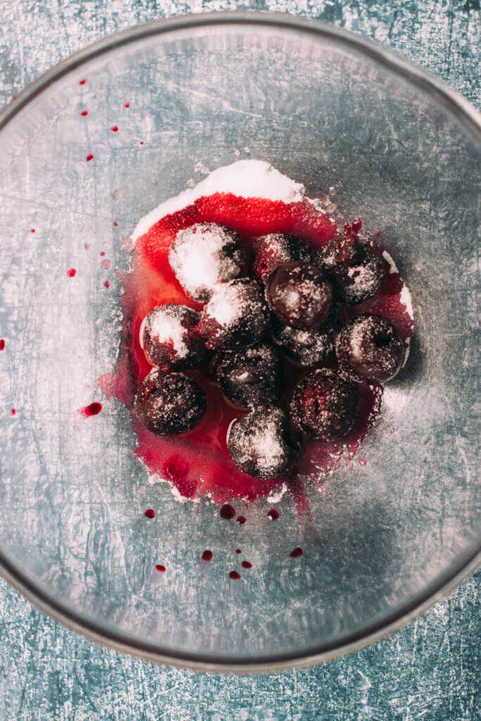 Cherries, sugar and brandy in a mixing bowl