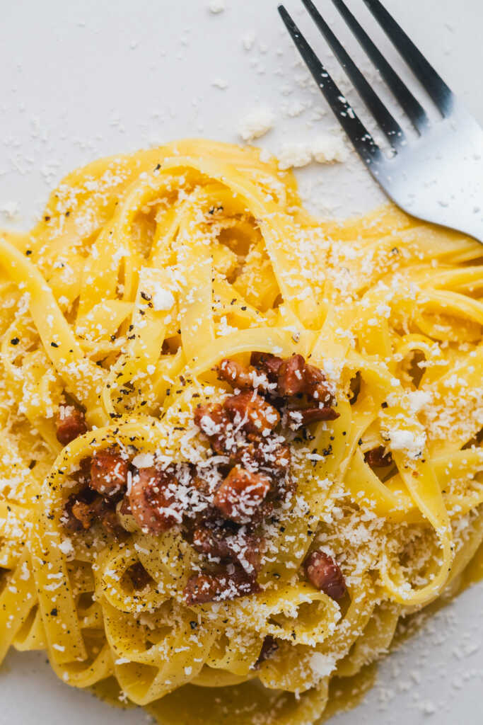 Carbonara on a plate with a fork