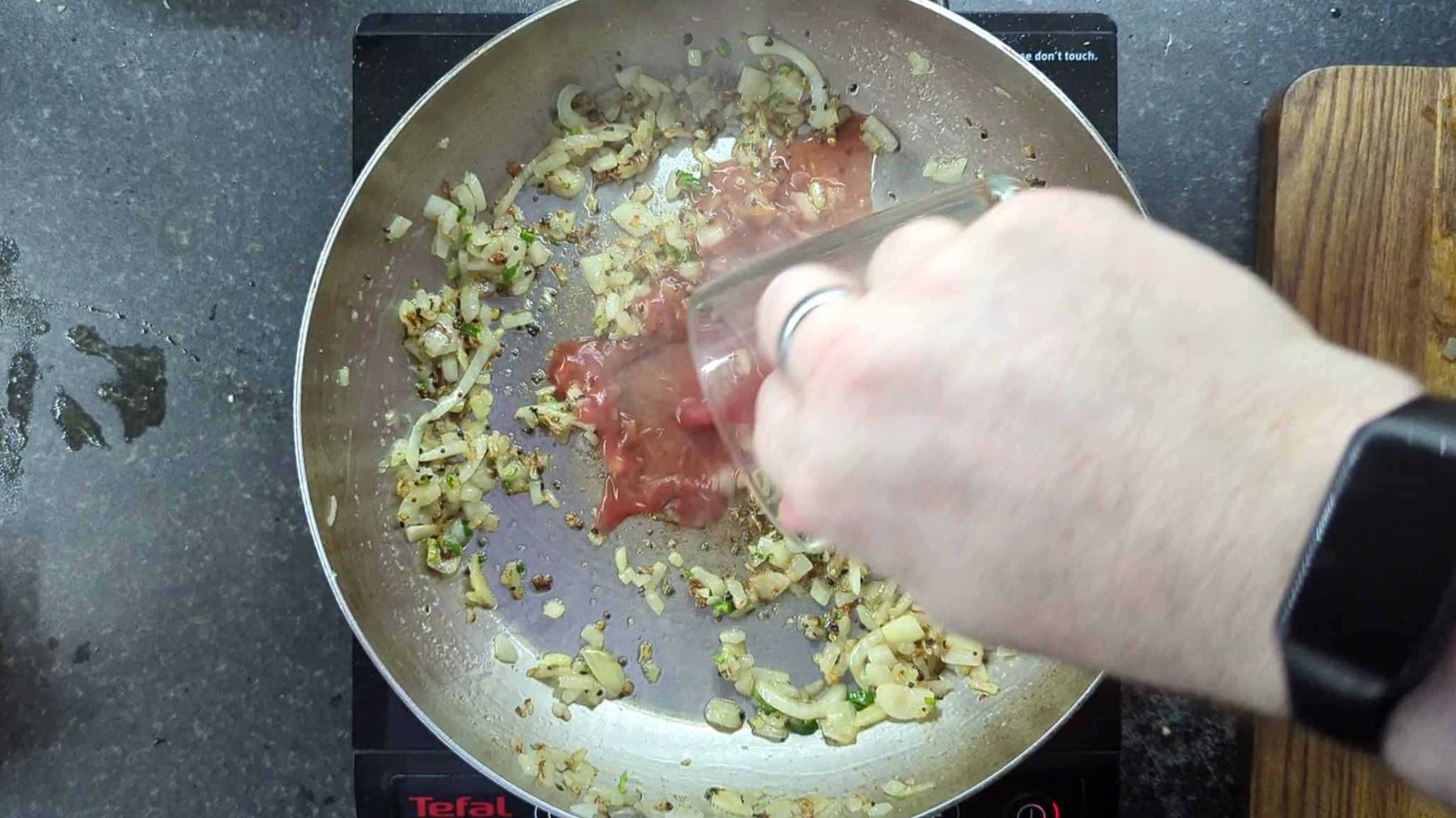 onions and passata in a frying pan