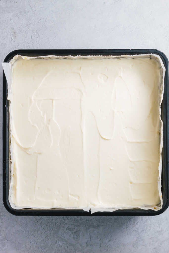 Assembled tiramisu recipe without rum in a square cake tin without cocoa