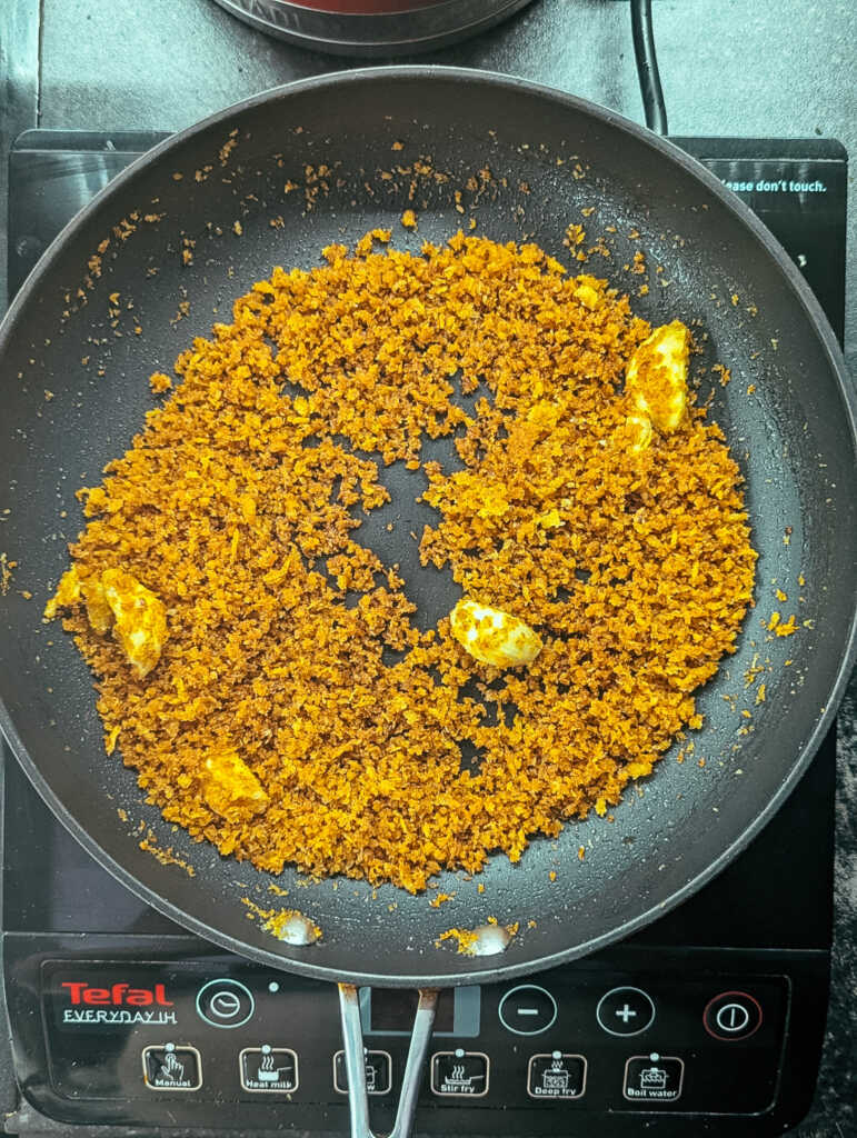 Golden pangrattato breadcrumbs in a pan with garlic