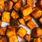 Close up of air fryer sweet potato cubes