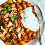 Ras el hanout curry in a bowl with yoghurt and herbs on top