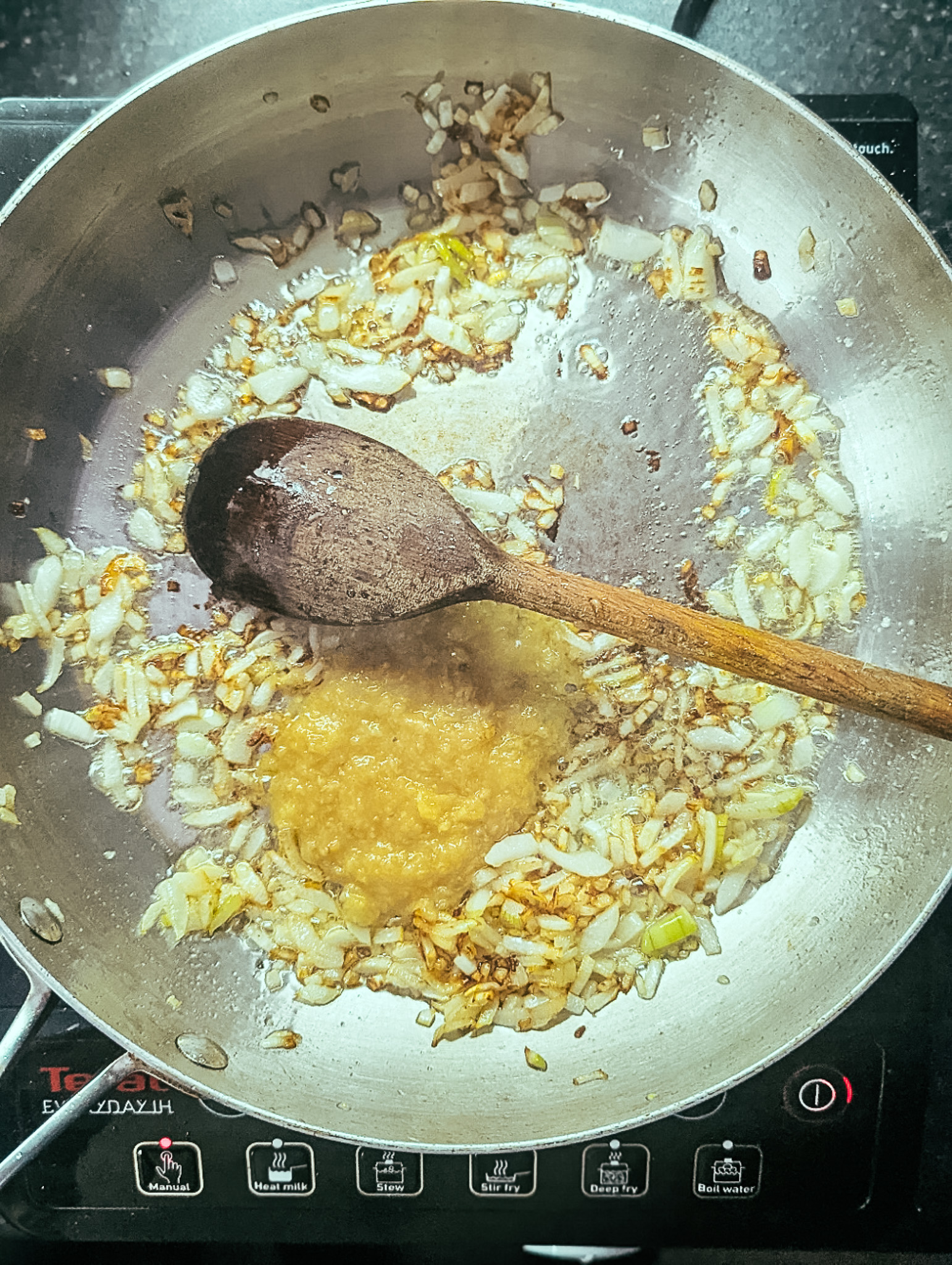 onions and garlic ginger paste in a frying pan
