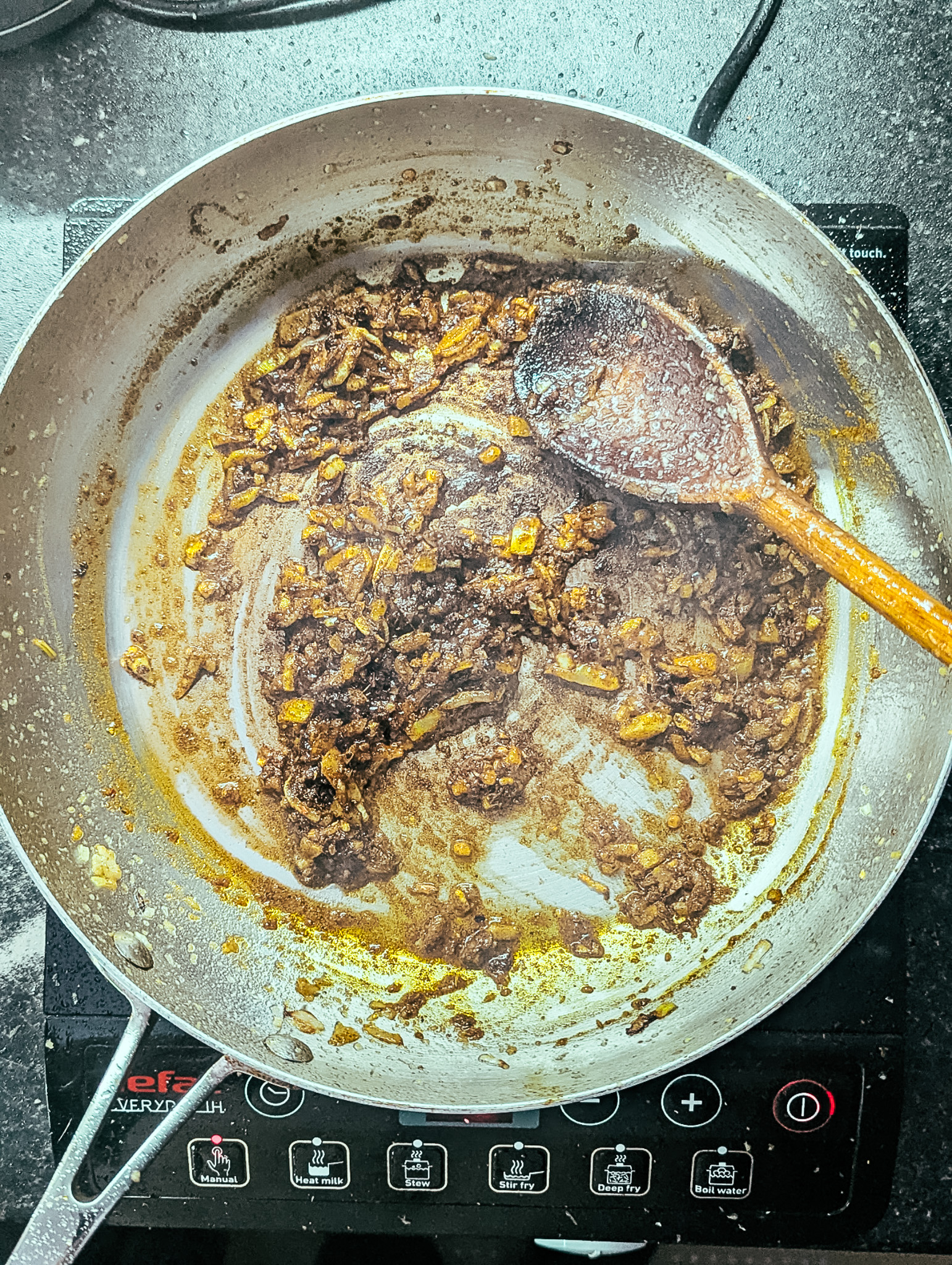 cooked spices and onions in a frying pan