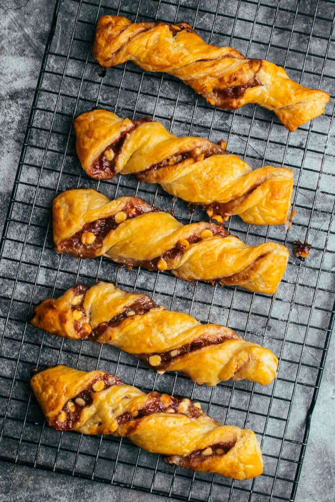 white chocolate and raspberry torsades served on a cooling rack