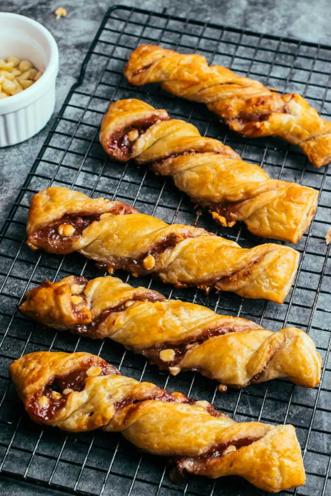 white chocolate and raspberry torsades served on a cooling rack